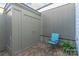 A quaint brick patio features a blue chair and greenery at 3615 Maple Glenn Ln, Charlotte, NC 28226