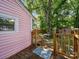Charming back porch with wooden railings, steps, and a view of the lush backyard at 408 S Ellis St, Salisbury, NC 28144