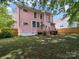 Spacious backyard with a wooden deck, lush greenery, and ample space for outdoor activities at 408 S Ellis St, Salisbury, NC 28144
