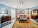 Bright bedroom with a four-poster bed, vintage furniture, and a patterned rug at 408 S Ellis St, Salisbury, NC 28144