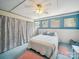 Cozy bedroom featuring blue accents, soft lighting, and a decorative privacy curtain at 408 S Ellis St, Salisbury, NC 28144