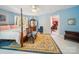 Bedroom featuring a canopy bed, vintage furniture, and view into an office at 408 S Ellis St, Salisbury, NC 28144