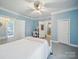 Blue bedroom with a white bed, light blue walls and an adjoining bath area at 408 S Ellis St, Salisbury, NC 28144