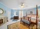 Light blue bedroom with a fireplace, canopy bed, and decorative rug at 408 S Ellis St, Salisbury, NC 28144