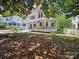 View of the pink Victorian home from the yard, showcasing its charming exterior and inviting porch at 408 S Ellis St, Salisbury, NC 28144