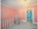 Upper level hallway features chandelier lighting, and access to other rooms at 408 S Ellis St, Salisbury, NC 28144
