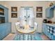 A charming breakfast nook in a blue and white kitchen with four chairs and vintage artwork at 408 S Ellis St, Salisbury, NC 28144