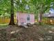 Backyard featuring a cozy outbuilding with a small porch and peaceful ambiance at 408 S Ellis St, Salisbury, NC 28144