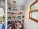 Functional pantry with ample shelving for storage and light from a window at 408 S Ellis St, Salisbury, NC 28144