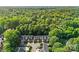 Beautiful aerial view of townhomes nestled in mature landscaping and trees with a pool at 4460 Coventry Row Ct, Charlotte, NC 28270