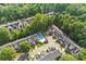 Aerial view of townhomes and community pool surrounded by mature trees at 4460 Coventry Row Ct, Charlotte, NC 28270