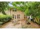 Private patio with a fire pit and mature landscaping, perfect for outdoor entertaining at 4460 Coventry Row Ct, Charlotte, NC 28270