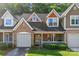 Charming townhome featuring a brick facade, attached garage, and inviting front porch at 4460 Coventry Row Ct, Charlotte, NC 28270