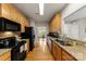 Well-lit kitchen featuring sleek appliances, wood cabinets, and granite countertops at 4460 Coventry Row Ct, Charlotte, NC 28270