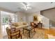 Inviting living room with hardwood floors, neutral paint, bright lighting, and a ceiling fan at 4460 Coventry Row Ct, Charlotte, NC 28270