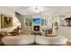 Open living room with a fireplace, media center, light paint and access to the front door at 4460 Coventry Row Ct, Charlotte, NC 28270