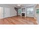 Bright living room with hardwood floors, fireplace, and multiple windows offering natural light at 4460 Coventry Row Ct, Charlotte, NC 28270
