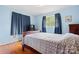 Bedroom with hardwood floors, one window, and blue walls at 518 W School St, Maiden, NC 28650