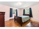 Bedroom with hardwood floors, two windows, and classic furnishings at 518 W School St, Maiden, NC 28650