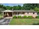 Charming brick home with manicured lawn and decorative white railing on the front porch at 518 W School St, Maiden, NC 28650
