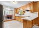 Eat-in kitchen with wood paneled walls, view to dining area, and white countertops at 518 W School St, Maiden, NC 28650