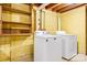 Bright basement laundry area features a washer and dryer, and ample storage at 518 W School St, Maiden, NC 28650