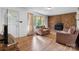 Cozy living room featuring a brick fireplace and ample natural light from the front door window at 518 W School St, Maiden, NC 28650