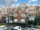 Exterior front view of a red brick building with a well-kept lawn and mature trees at 5617 Fairview Rd # 9, Charlotte, NC 28209