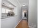 Inviting hallway with a passthrough to the kitchen and views of the front door and coat rack at 5617 Fairview Rd # 9, Charlotte, NC 28209