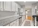 Bright kitchen featuring granite counters, subway tile backsplash, and stainless steel appliances at 5617 Fairview Rd # 9, Charlotte, NC 28209