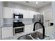 Modern kitchen with white cabinets, stainless steel appliances, and granite countertops, perfect for cooking at 5617 Fairview Rd # 9, Charlotte, NC 28209