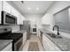 Galley kitchen with stainless appliances, granite countertops, white cabinets and in-unit laundry at 5617 Fairview Rd # 9, Charlotte, NC 28209