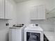 Laundry room with washer, dryer, and storage cabinets at 5617 Fairview Rd # 9, Charlotte, NC 28209