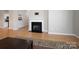 Open living room featuring hardwood floors, fireplace, and a kitchen view for seamless entertaining at 5617 Fairview Rd # 9, Charlotte, NC 28209