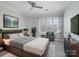 Main bedroom featuring a ceiling fan, a large window and neutral-toned decor at 5617 Fairview Rd # 9, Charlotte, NC 28209