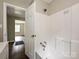 Bathroom with white tile tub/shower combo, modern fixtures, and wood-look floors at 6225 Macon St, Charlotte, NC 28208