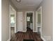 Hallway with doors leading to rooms and wood-look floors at 6225 Macon St, Charlotte, NC 28208