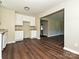 Eat-in kitchen boasts bright white cabinets and granite countertops, open to the living room at 6225 Macon St, Charlotte, NC 28208