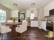 Bright kitchen with white cabinetry, stainless steel appliances, and a breakfast nook bathed in natural light at 6225 Macon St, Charlotte, NC 28208