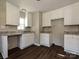 Bright kitchen featuring granite countertops, white cabinets, and modern lighting fixtures at 6225 Macon St, Charlotte, NC 28208