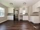 Eat-in kitchen featuring white cabinetry and granite countertops, complemented by modern lighting at 6225 Macon St, Charlotte, NC 28208