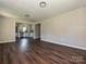 Bright, open-concept living area with wood floors seamlessly flowing into the adjacent room at 6225 Macon St, Charlotte, NC 28208