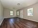 Bright living room features beautiful floors, neutral walls, and natural light from multiple windows at 6225 Macon St, Charlotte, NC 28208