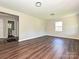 Spacious living room with wood-look floors and natural light from a large window at 6225 Macon St, Charlotte, NC 28208