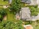 Aerial view of a home featuring a well-maintained lawn, mature trees and a paver patio perfect for outdoor living at 6533 Derby Nw Ln, Concord, NC 28027