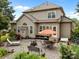 Spacious backyard with patio area including outdoor furniture, grill and garden, ideal for entertaining or relaxation at 6533 Derby Nw Ln, Concord, NC 28027