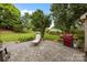 A spacious backyard featuring a patio, lounge chair, grill and lush greenery, creating an inviting outdoor space at 6533 Derby Nw Ln, Concord, NC 28027
