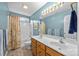 Dual-sink bathroom vanity with modern fixtures, mirror and shower with a decorative curtain at 6533 Derby Nw Ln, Concord, NC 28027