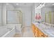 Bathroom featuring a soaking tub, glass shower, and double vanity with granite counters at 6533 Derby Nw Ln, Concord, NC 28027