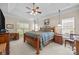 Bedroom with a wooden bed frame, natural light, and cozy carpeting at 6533 Derby Nw Ln, Concord, NC 28027